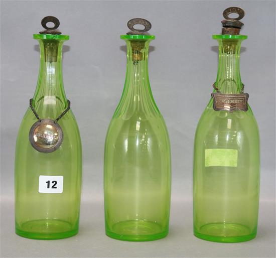 A set of three Victorian uranium glass decanters, with plated labels, the Gin label is silver approx. height 28.5cm